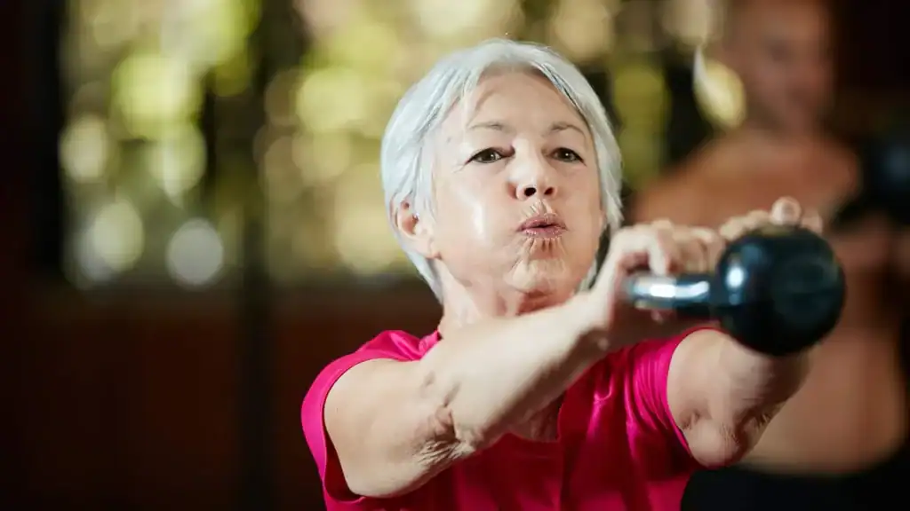 Toning Arms After 60: Empowering Womens Fitness Through Effective Weight Training 1 Older woman doing weight training Canvey Island to help her strength and longevity